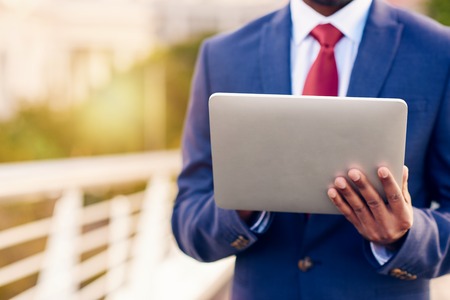 Closeup of a businessman using a digital tablet with the city in the backgroundの写真素材