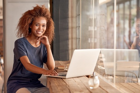 Portrait of an attractive young woman working on a laptop while sitting in a cafeの写真素材