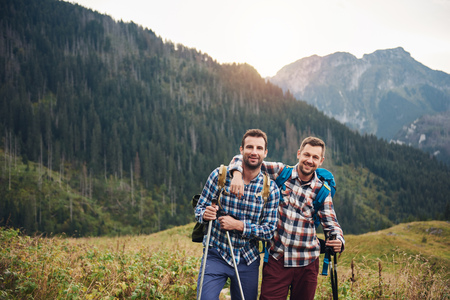 Two friends trekking together in the mountainsの写真素材