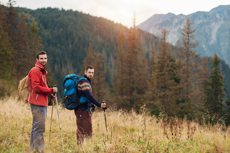 Two young men out trekking in the wildernessの写真素材