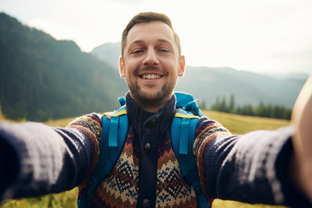 Smiling hiker taking a selfie in the great outdoorsの写真素材