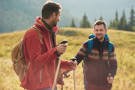 Hikers talking together while trekking in the wildernessの写真素材