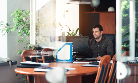 Confident businessman at work in his officeの写真素材