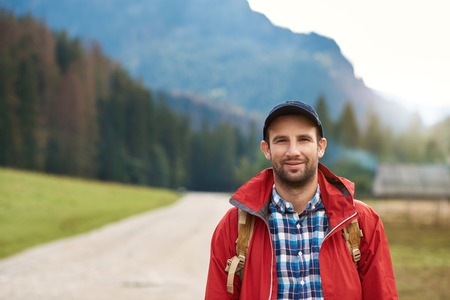 Young man ready to hike in the hills
