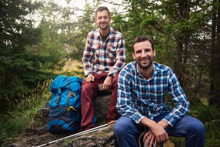 Smiling hikers taking a break in the woods