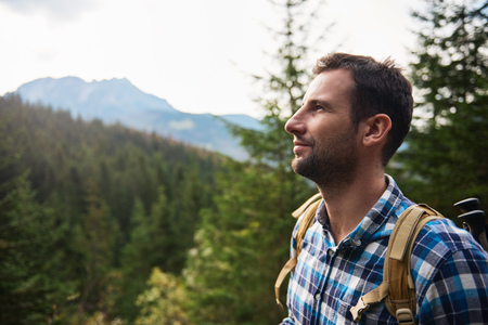 Hiker admiring the view high up in the hillsの写真素材