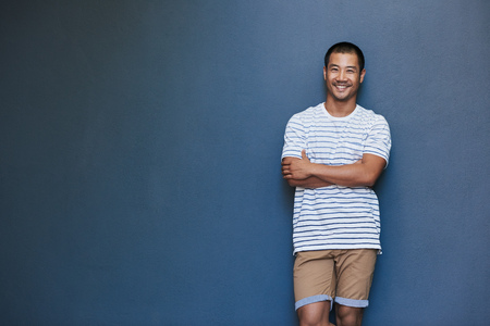 Smiling young Asian man with a laid back attitudeの写真素材