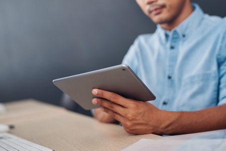 Young designer using a tablet at his office desk