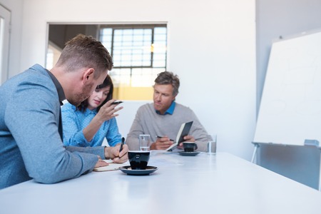 Work colleagues talking business together in an office