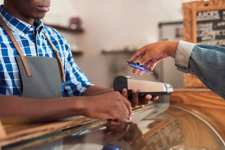 Cafe customer paying for her purchace with nfc technologyの写真素材