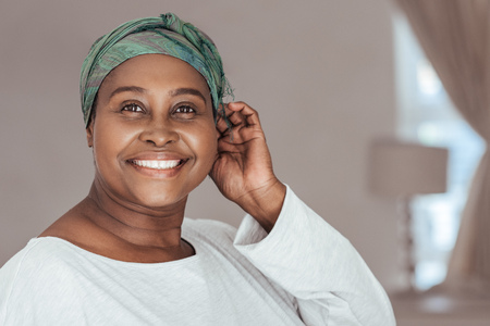 Happy adult African woman wearing on a stylish headscarf
