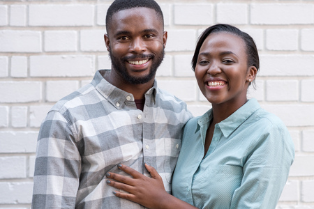 Smiling African couple standing together in the cityの写真素材