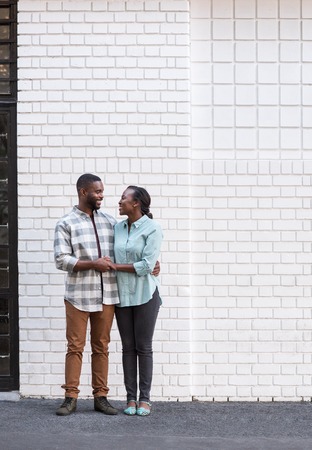 Smiling young African couple standing together in the cityの写真素材