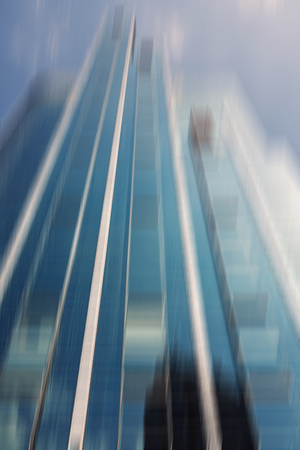 Defocused glass skyscraper in the commercial district of a cityの写真素材