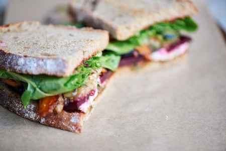 Delicious gourment sandwich of mixed vegetables on a serving boardの写真素材