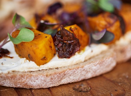 Delicious butternut and beet open faced sandwich on a board
