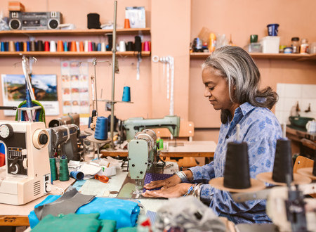 Mature seamstress working in her sewing workshopの写真素材