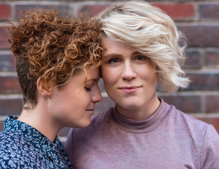 Content young lesbian couple standing affectionately together outsideの写真素材