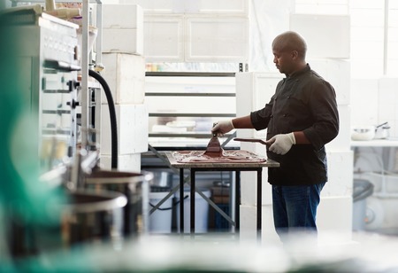 Artisanal chocolate maker working at a factory tableの写真素材