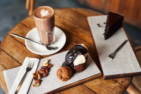 Delicious slices of chocolate desserts sitting on a cafe tableの写真素材
