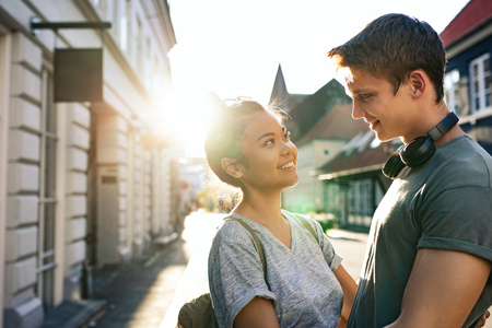 Affectionate young couple looking at each other in the cityの写真素材