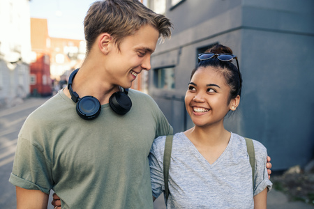Smiling young couple standing together in the city
