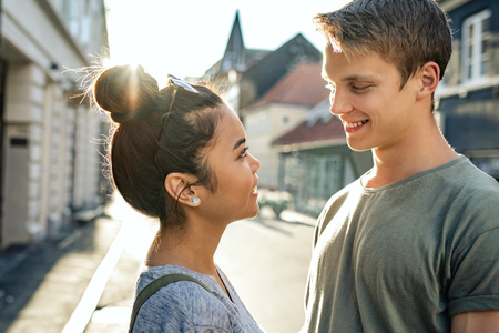 Young couple looking into each others eyes in the cityの写真素材