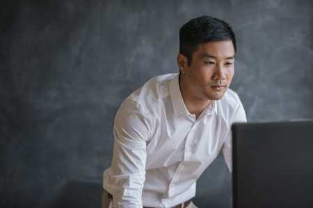 Asian businessman working on a computer in an officeの写真素材