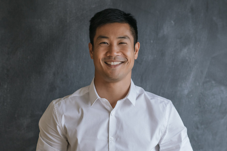 Content Asian businessman standing in front of a blank chalkboardの写真素材