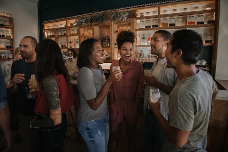 Diverse young friends enjoying an evening in a pub together