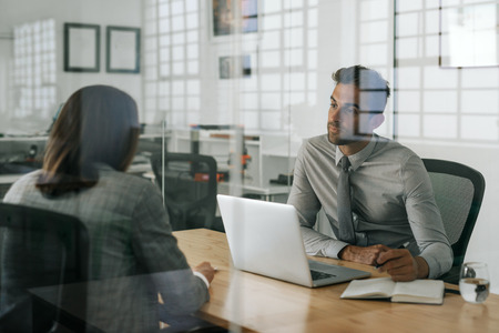 Manager interviewing a job applicant inside of his officeの写真素材