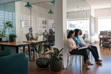 Manager conducting interviews with a group of applicants at workの写真素材