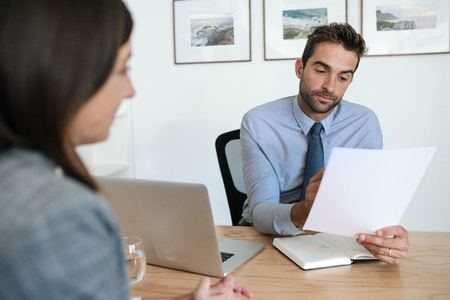 Office manager reading a resume during an interviewの写真素材
