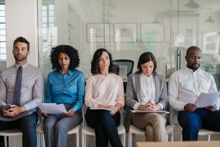 Job applicants waiting for their interviews in an officeの写真素材