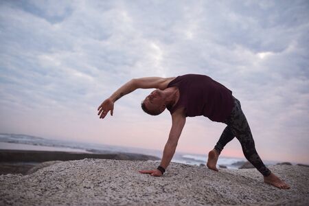 Man doing the wild thing pose by the ocean