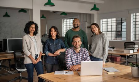 Diverse team of smiling designers working together in an officeの写真素材