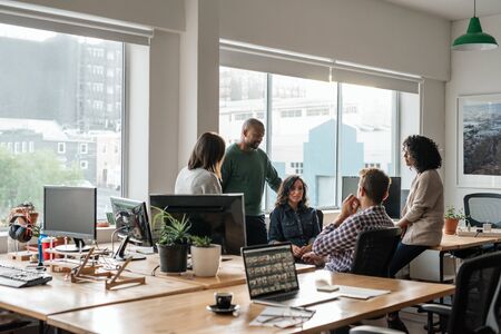 Smiling group of diverse designers meeting together in their officeの写真素材
