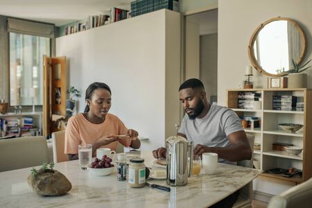 Young African American couple having breakfast in the morningの写真素材