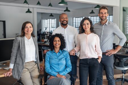 Smiling group of diverse businesspeople working in an officeの写真素材