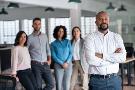 Smiling African American manager and his team in an officeの写真素材