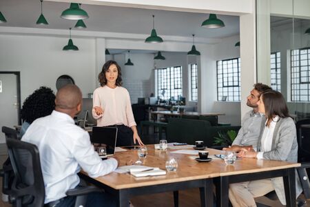Businesswoman meeting with her diverse team in an officeの写真素材