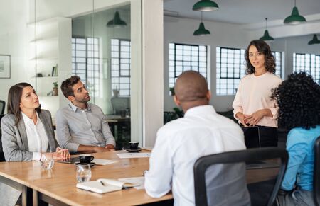 Young businesswoman talking with her team in an officeの写真素材