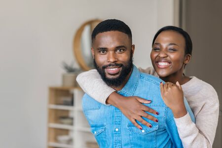 Carefree young African American couple relaxing at homeの写真素材