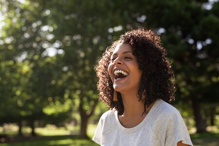 Laughing young woman enjoying a sunny day in the parkの写真素材