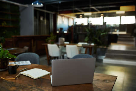 Laptop sitting on a desk in an office after hours