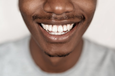Closeup of a young African man with a big smileの写真素材