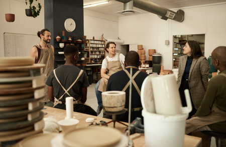 Diverse ceramics studio team talking during a meeting togetherの写真素材
