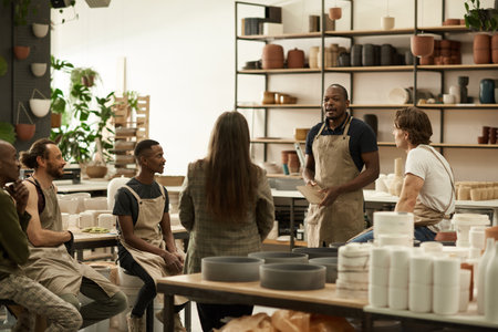 Diverse group of ceramics workers meeting together in a studioの写真素材