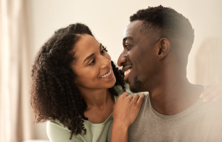 Loving multiracial couple looking at each other and smilingの写真素材