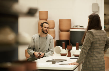 Ceramics studio owner and a colleague discussing designsの写真素材